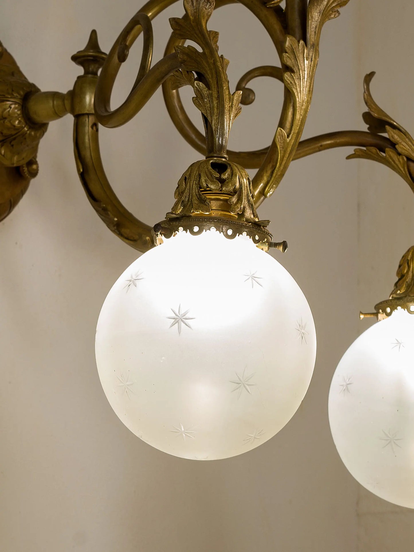 Applique accesa che diffonde la luce attraverso i vetri molati a motivi stellati. | Lo Stile Italiano
