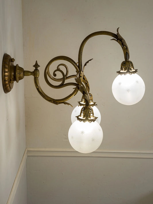 Lampada a parete Liberty a tre luci con decori fogliati e struttura in bronzo | Lo Stile Italiano