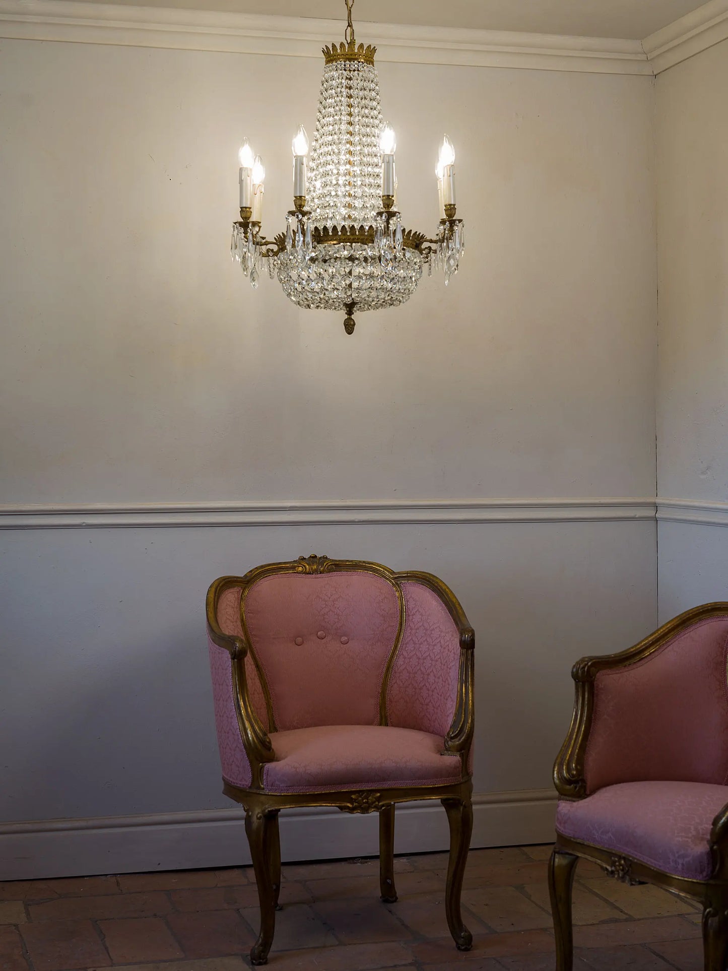 Antique chandelier photographed with two Napoleon III armchairs. | Lo Stile Italiano