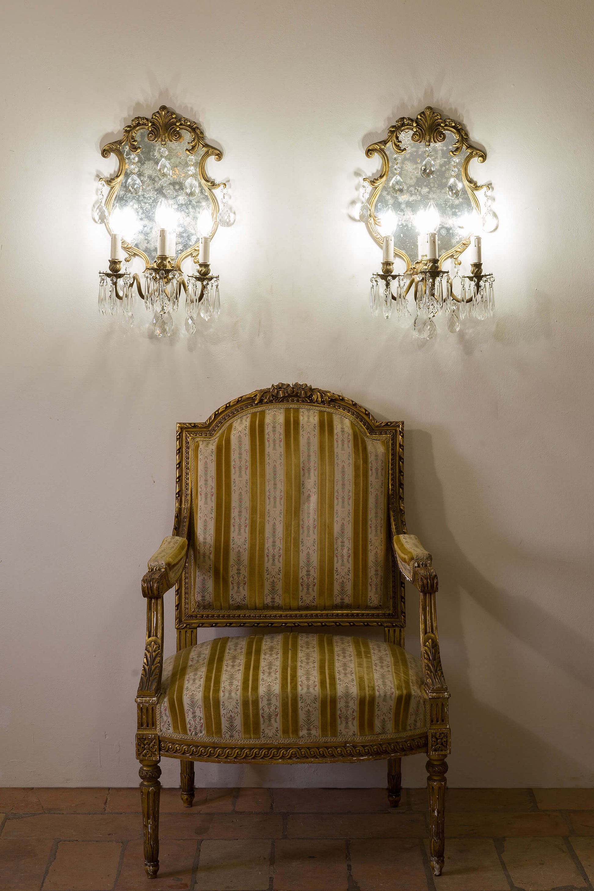 Infondi al tuo ambiente una bellezza senza tempo con queste applique vintage. Lo specchio al centro intensifica la luminosità delle tre lampadine E14, mentre la struttura in bronzo esprime eleganza e resistenza. Le macchie di ossidazione argento sullo specchio conferiscono un tocco unico, esaltando il fascino del tempo passato. | Lo Stile Italiano