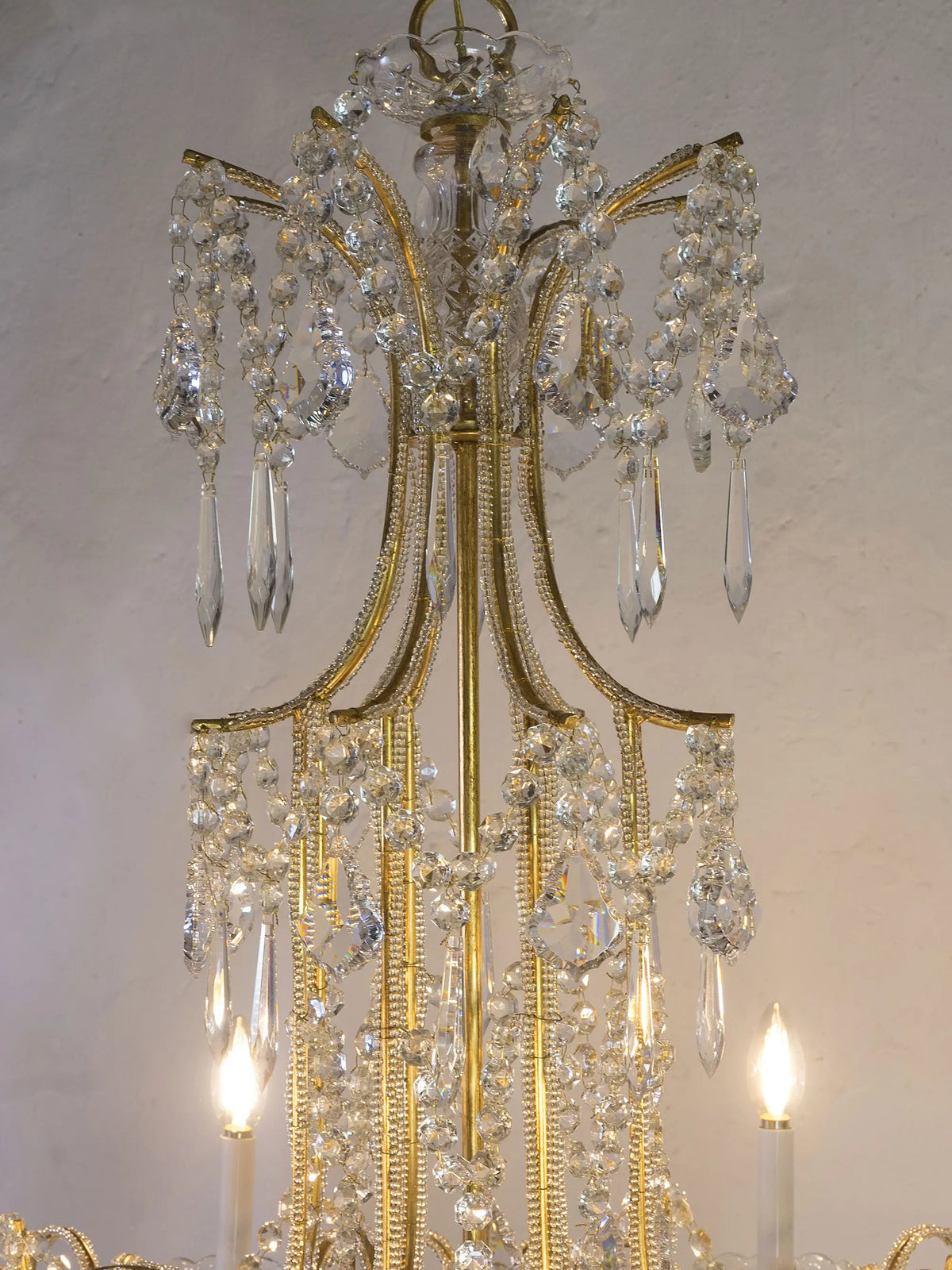 detail of the lit chandelier with illuminated crystals | Lo Stile Italiano