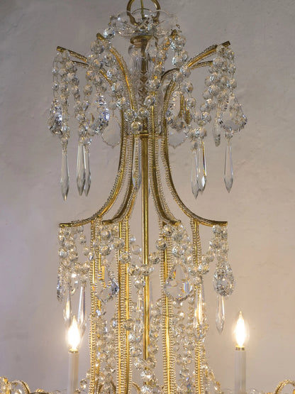 detail of the lit chandelier with illuminated crystals | Lo Stile Italiano