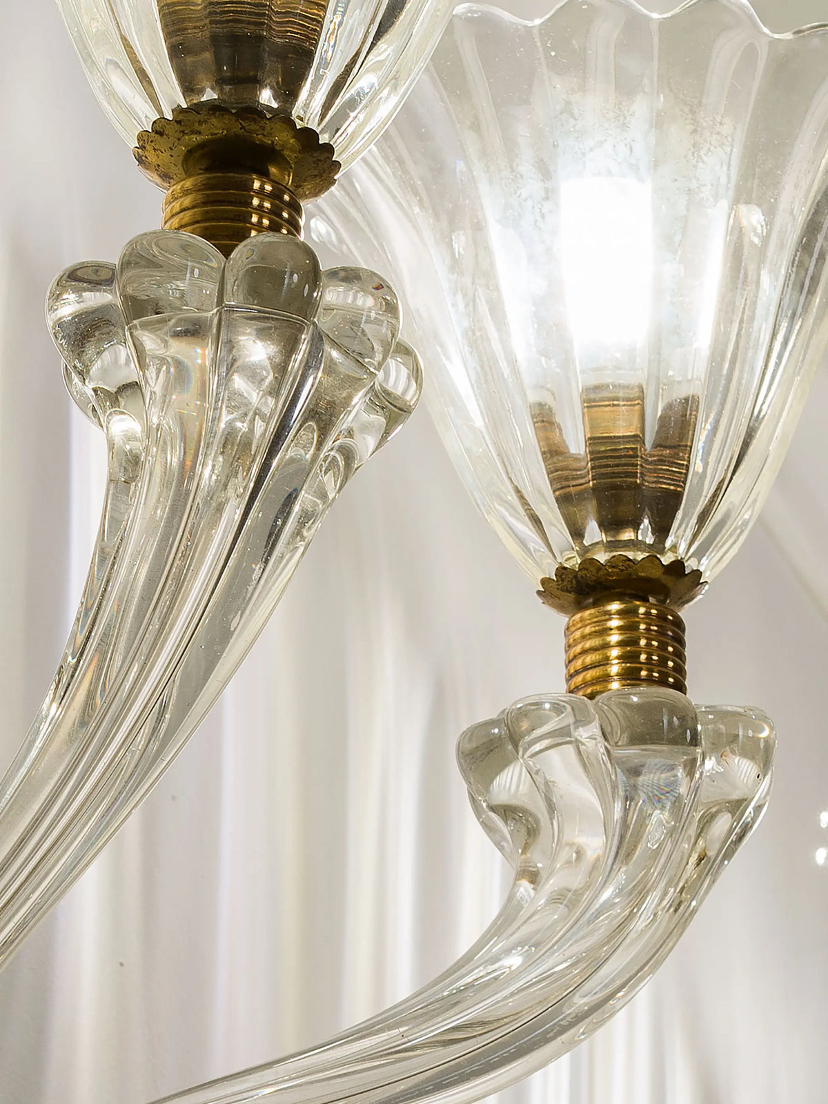Detail of an Art Deco wall light with curved arms and ribbed glass shades | Lo Stile Italiano
