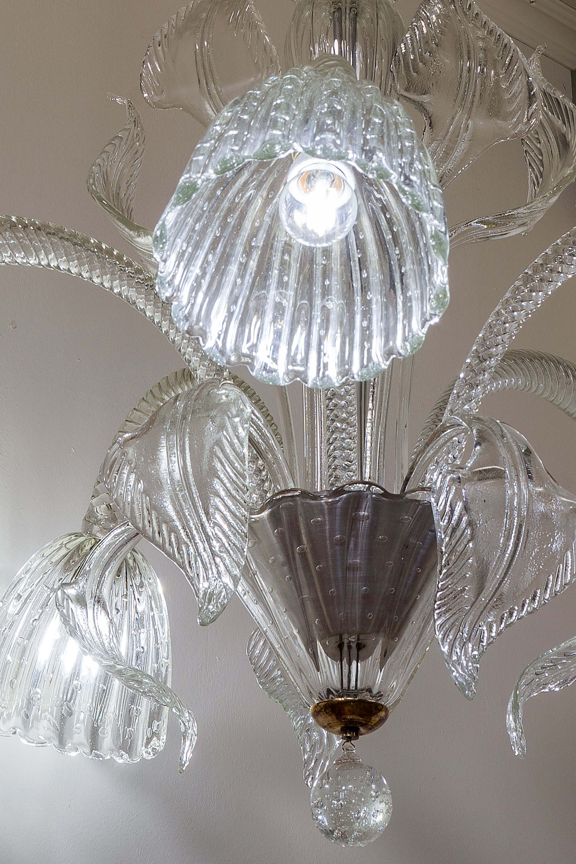 Dettagli artigianali: bracci vetro-Torchon e coppe imponenti caratterizzano il lampadario-Murano.|Lo Stile Italiano