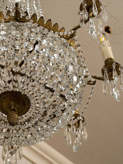 Italian chandelier from the 1940s in Empire style, shaped like a hot air balloon.  
Made of brass with frosted glass chains converging at the upper crown. Eight internal lights with wooden candles. | Lo Stile Italiano