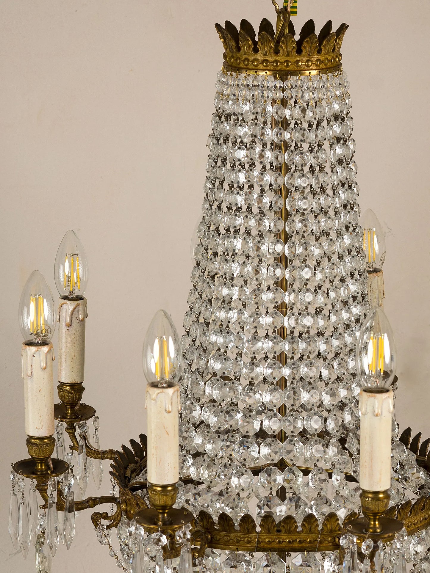 Antique chandelier with a brass structure and classic decorations that evoke the imperial period. | The Italian-Roman Style