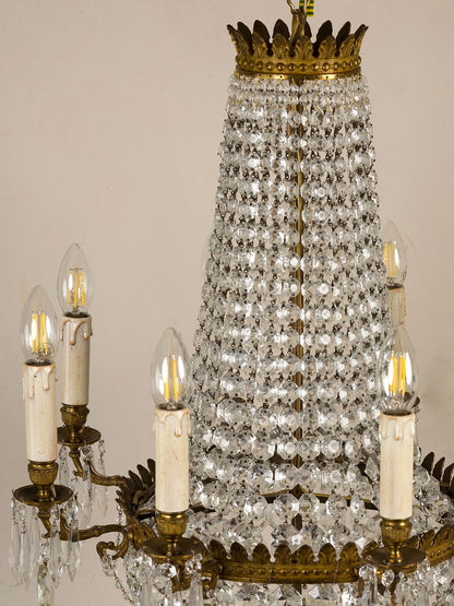 Antique chandelier with a brass structure and classic decorations that evoke the imperial period. | The Italian-Roman Style